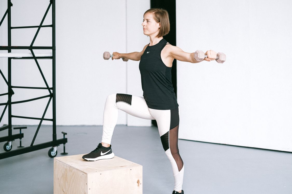 Sportlerin beim Hanteltraining im Fitnessstudio